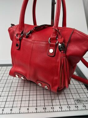 Tignanello Red Orange  Leather Tassel Tote Handbag. Metal accents.